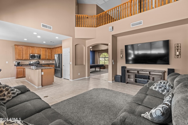 tiled living room with a high ceiling, billiards, and sink