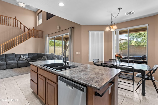 kitchen with dishwasher, a kitchen island with sink, plenty of natural light, and sink