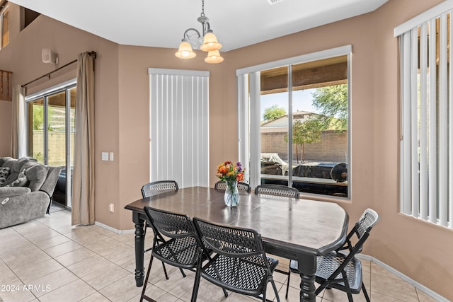 tiled dining area with a chandelier and a healthy amount of sunlight