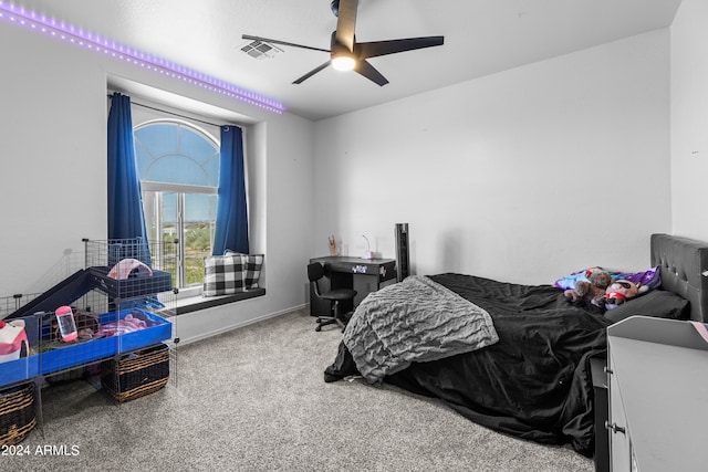 bedroom featuring ceiling fan and carpet