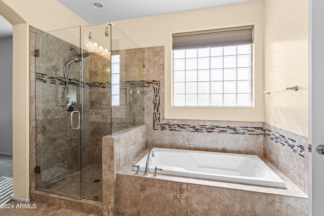 bathroom featuring separate shower and tub