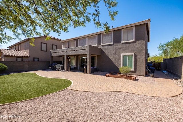 back of house featuring a yard and a patio area