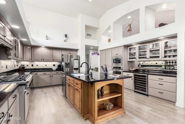 kitchen with visible vents, wine cooler, gray cabinets, appliances with stainless steel finishes, and a sink