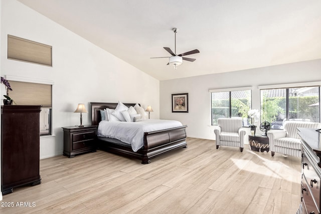 bedroom with light wood-type flooring, lofted ceiling, and a ceiling fan