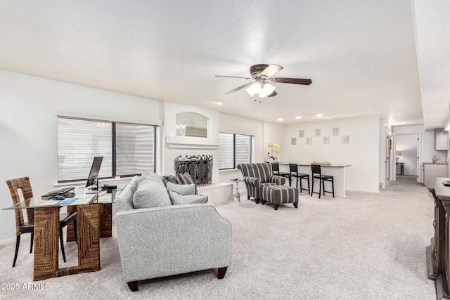 living room with light carpet and a ceiling fan