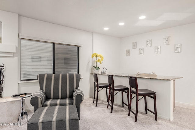 dining room featuring recessed lighting, baseboards, and light carpet