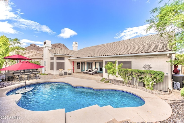 pool featuring central AC and a patio