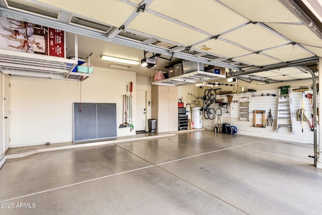 garage featuring a garage door opener and water heater