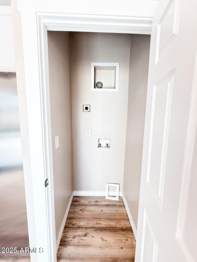 washroom featuring light wood-type flooring, washer hookup, hookup for an electric dryer, and baseboards