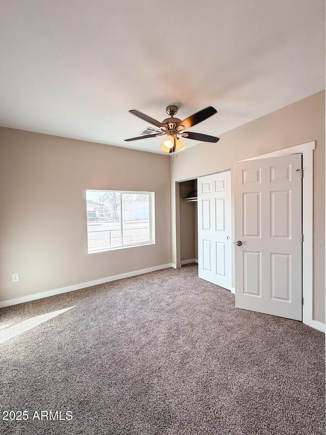 unfurnished bedroom featuring a closet, carpet flooring, ceiling fan, and baseboards