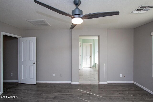 unfurnished bedroom with ceiling fan, a textured ceiling, and a closet