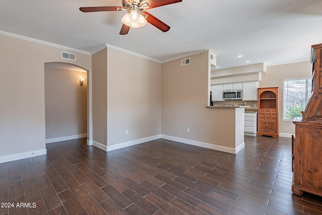 unfurnished living room featuring ceiling fan, crown molding, and dark hardwood / wood-style floors