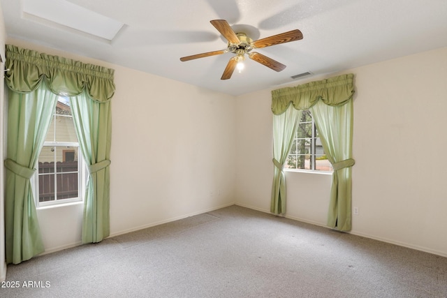 empty room featuring carpet flooring, baseboards, visible vents, and ceiling fan