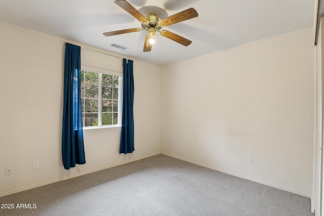 carpeted empty room with visible vents and ceiling fan