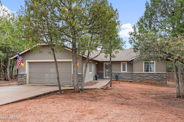 ranch-style house featuring fence, concrete driveway, roof with shingles, a garage, and stone siding