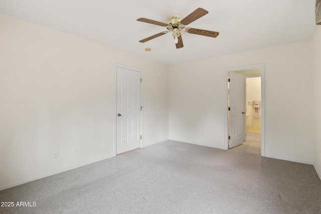 carpeted empty room featuring a ceiling fan