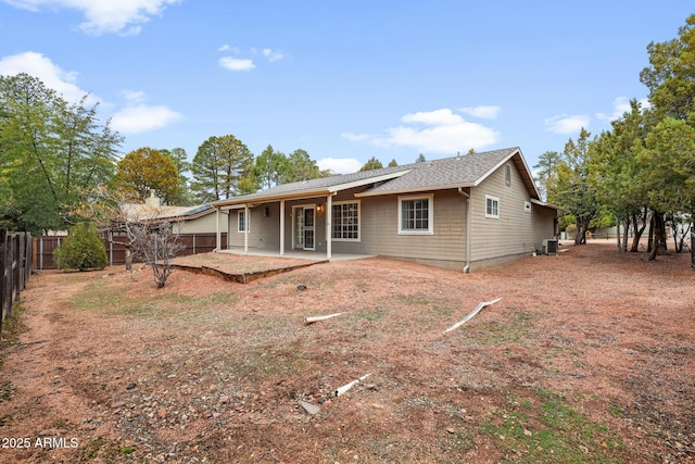 rear view of property featuring central air condition unit, a patio area, and a fenced backyard