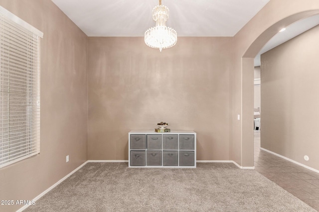 2945 E Clifton Ave, Gilbert, AZ 85295 - spare room featuring arched walkways, carpet floors, a chandelier, and baseboards