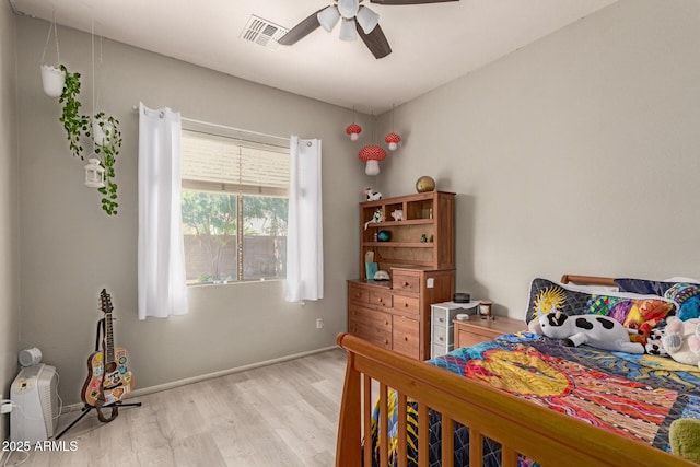 2945 E Clifton Ave, Gilbert, AZ 85295 - bedroom with light wood-type flooring, a ceiling fan, and baseboards