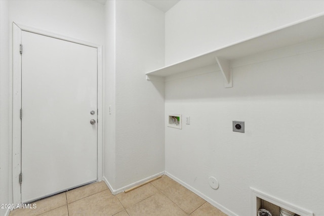 clothes washing area featuring hookup for a gas dryer, electric dryer hookup, washer hookup, light tile patterned floors, and baseboards