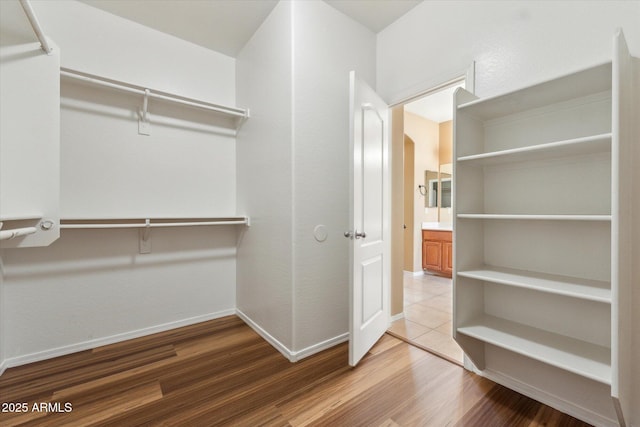 walk in closet featuring wood finished floors