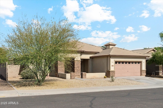 view of front of house featuring a garage, driveway, a tile roof, stone siding, and stucco siding