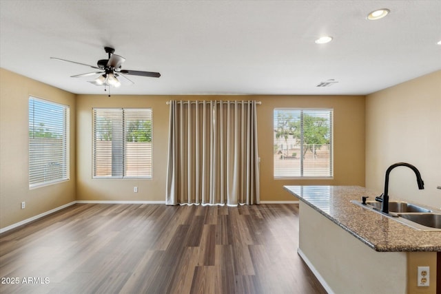 unfurnished living room featuring a sink, dark wood-style floors, ceiling fan, baseboards, and recessed lighting