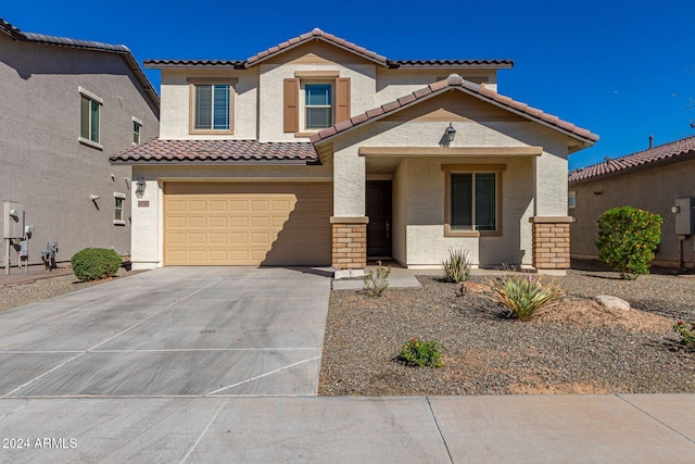 mediterranean / spanish-style home featuring a garage