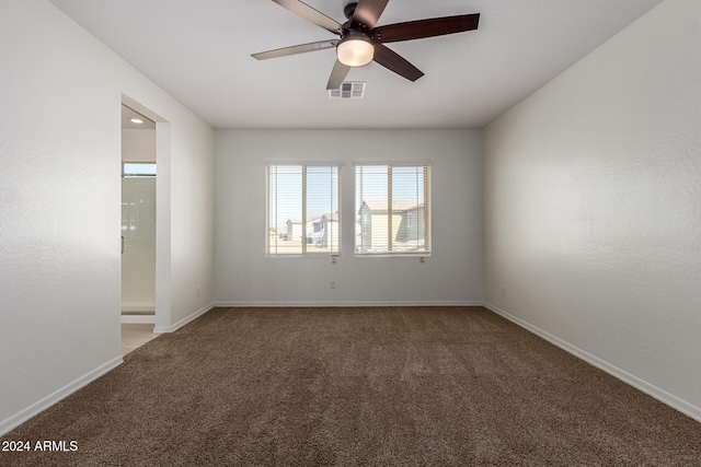 carpeted empty room featuring ceiling fan