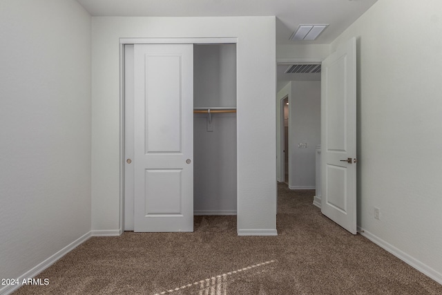 unfurnished bedroom with a closet and carpet