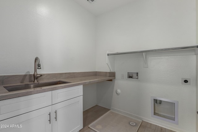 washroom with cabinets, washer hookup, light wood-type flooring, hookup for an electric dryer, and sink