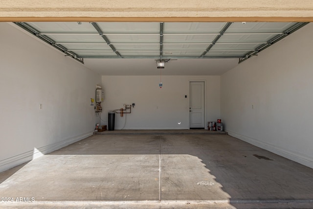 garage with a garage door opener and water heater