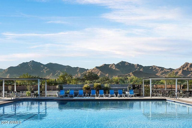 view of swimming pool featuring a patio area and a mountain view