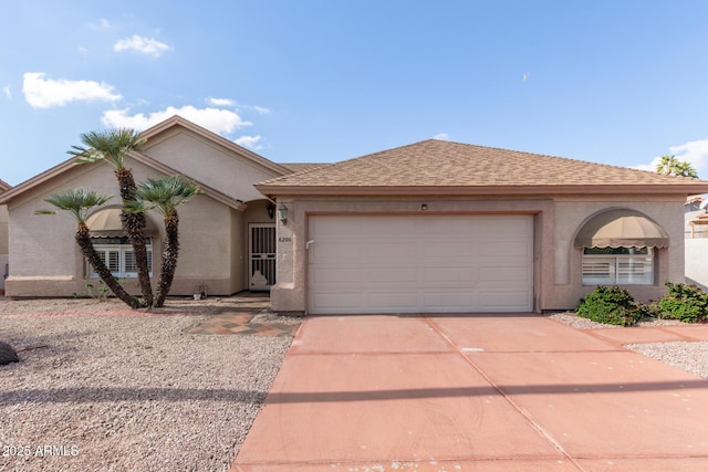 single story home with stucco siding, driveway, a shingled roof, and a garage