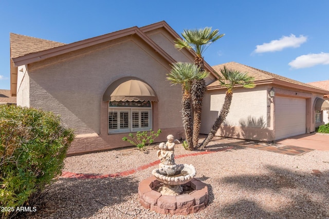 view of front facade featuring stucco siding and a garage