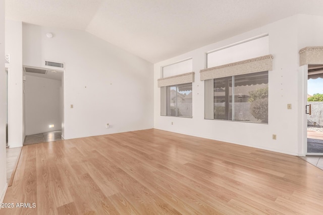 unfurnished living room with visible vents and wood finished floors