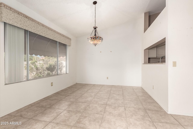 empty room with tile patterned floors and a sink