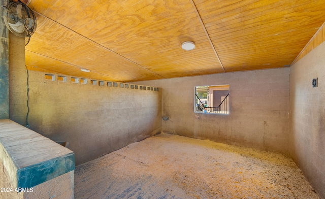 interior space featuring carpet floors and wooden ceiling