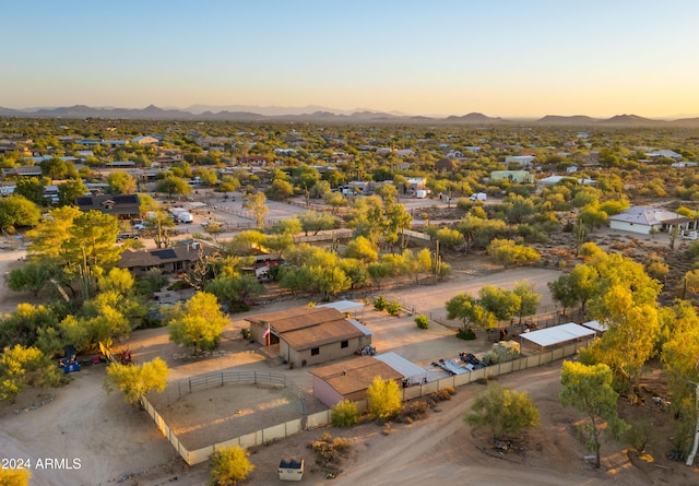 aerial view at dusk featuring a mountain view