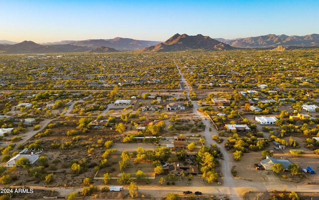 aerial view at dusk featuring a mountain view