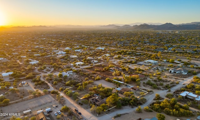 aerial view at dusk featuring a mountain view