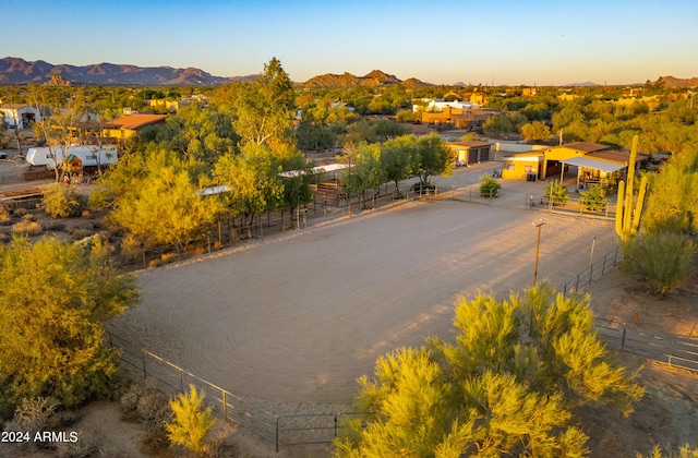 aerial view at dusk featuring a mountain view