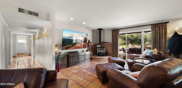 tiled living room featuring a wood stove