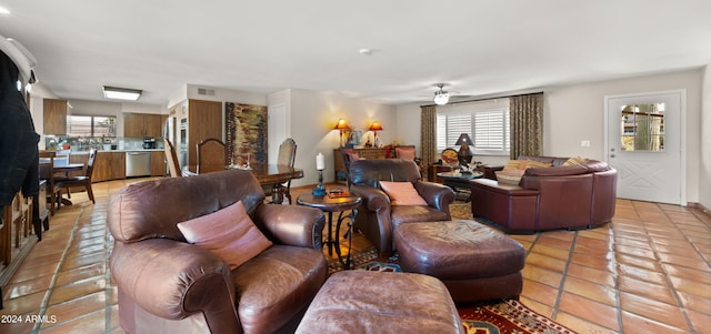 tiled living room with ceiling fan