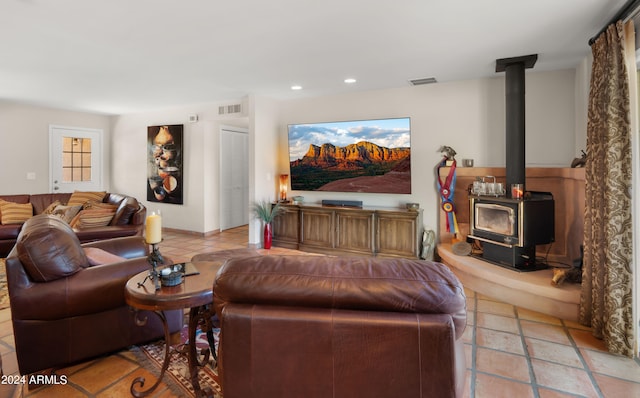 tiled living room featuring a wood stove