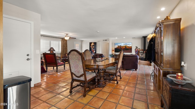 tiled dining space featuring ceiling fan