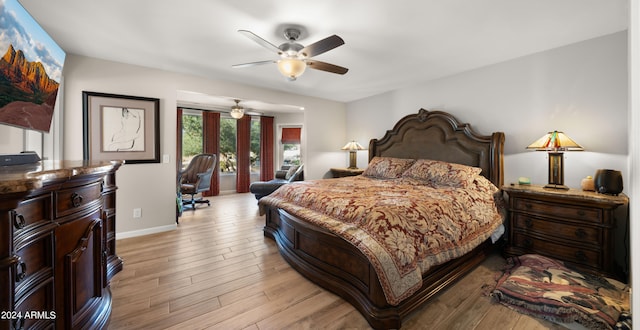 bedroom with light hardwood / wood-style floors and ceiling fan