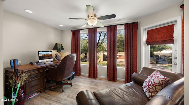 office area with light hardwood / wood-style flooring and ceiling fan