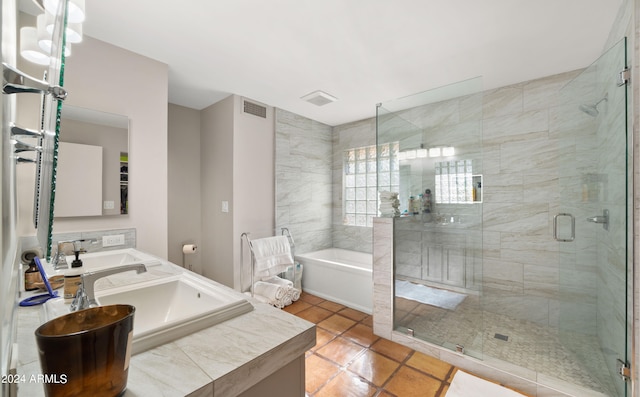 bathroom with independent shower and bath, vanity, and tile patterned floors