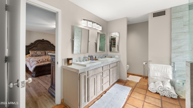 bathroom featuring hardwood / wood-style flooring, vanity, and toilet